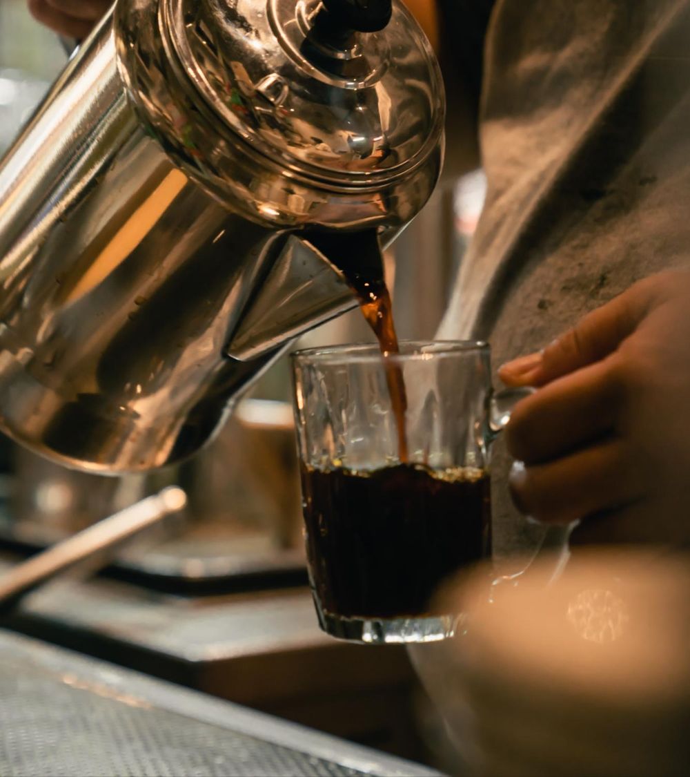 Coffee being poured at a neighbourhood cafe