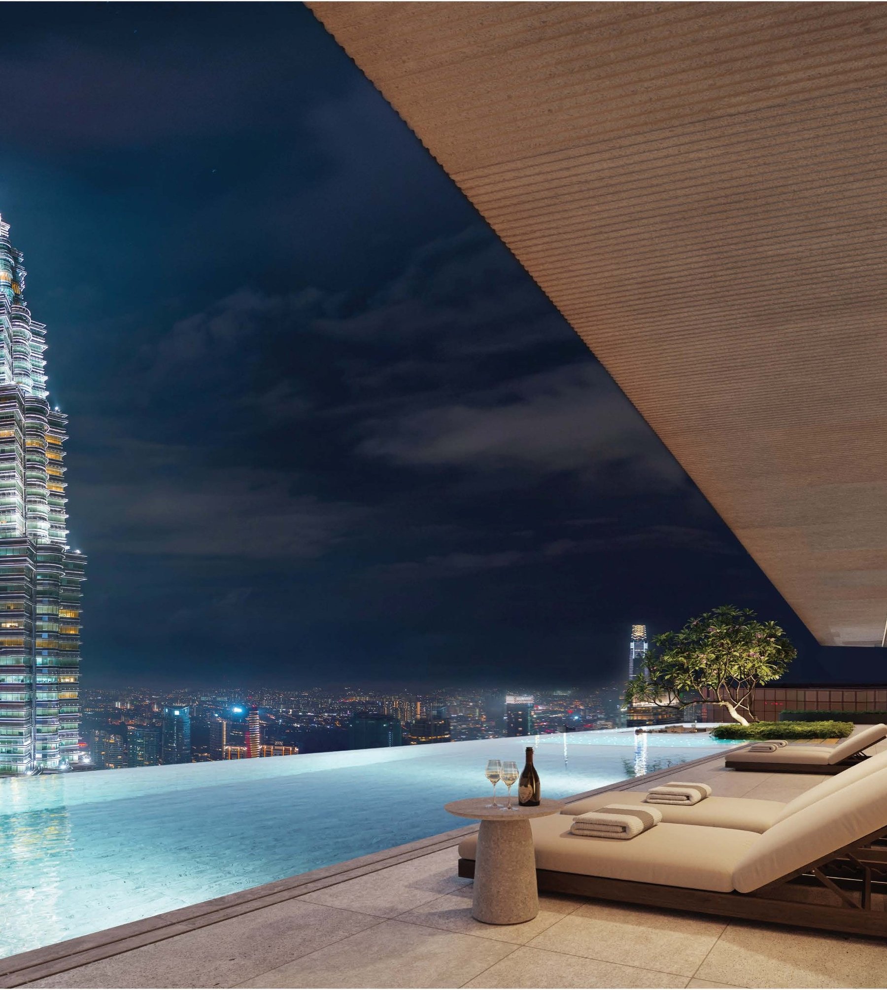 Infinity pool at CloutHaus Residences facing the Petronas Twin Towers at night