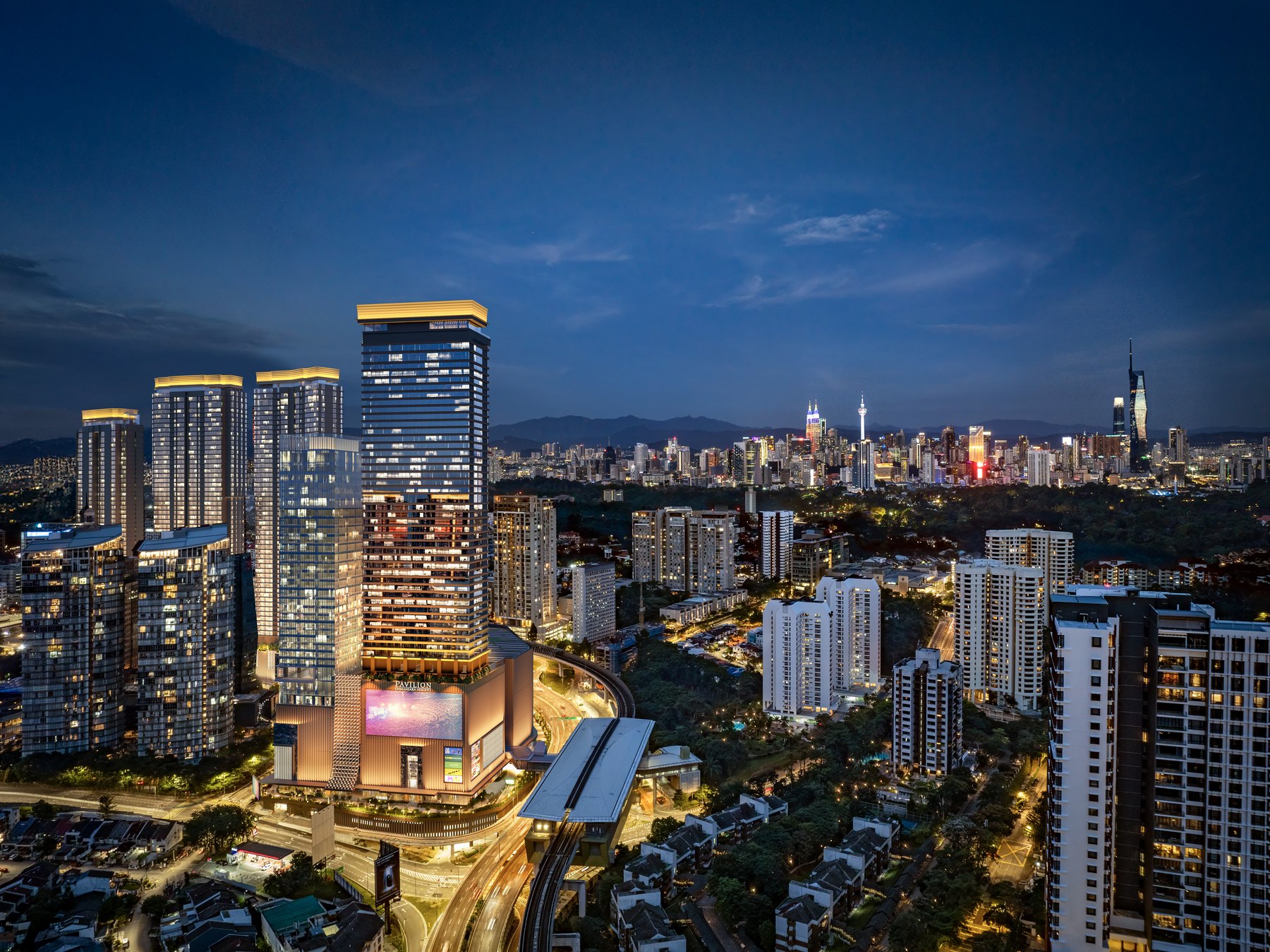 Pavilion Damansara Heights at night with the Kuala Lumpur skyline behind